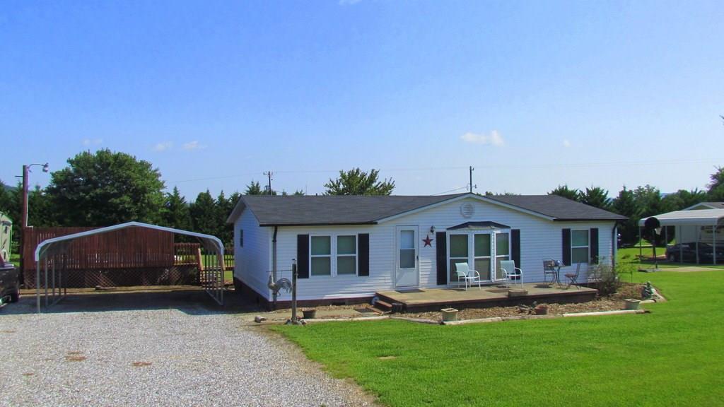 1317 Poole Gooden Road Hiddenite, NC 28636 - Photo 8 of 36 a front view of house with yard and patio