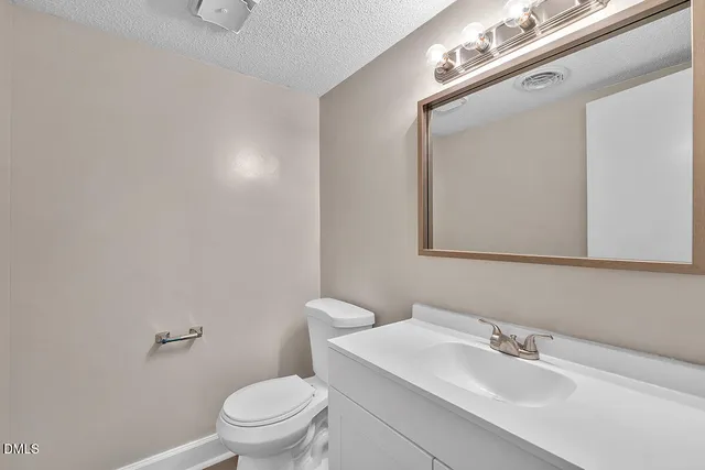 a bathroom with a sink a mirror and a toilet