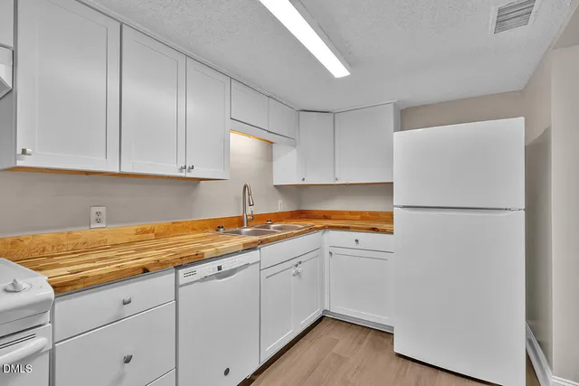 a kitchen with a sink and a refrigerator
