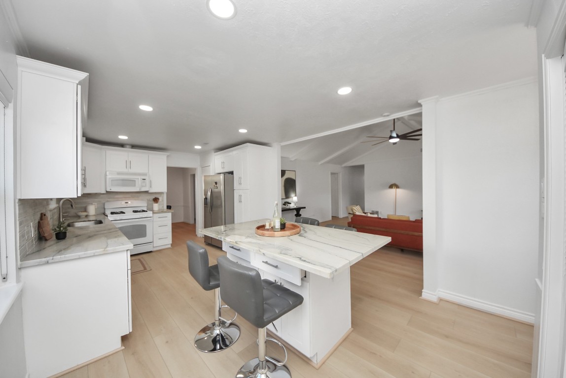 10719 Burgoyne Road Houston, TX 77042 - Photo 11 of 36 From this side, you can see how the kitchen opens up to the family room, creating an open and connected living space.
