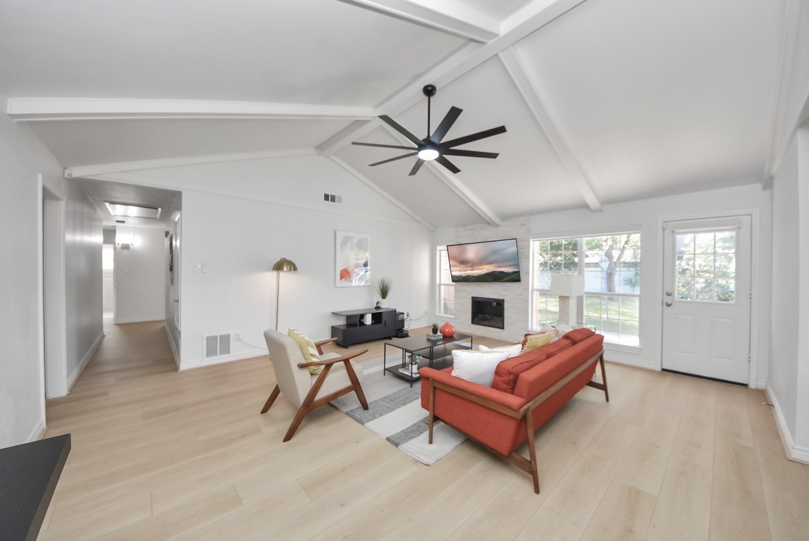10719 Burgoyne Road Houston, TX 77042 - Photo 13 of 36 From this side, you can really see how spacious the room is. You’ll also notice all the windows that bring in natural light and offer a peek of the backyard. You can access the backyard through this door or from the kitchen, and the hallway to the left leads to the bedrooms.