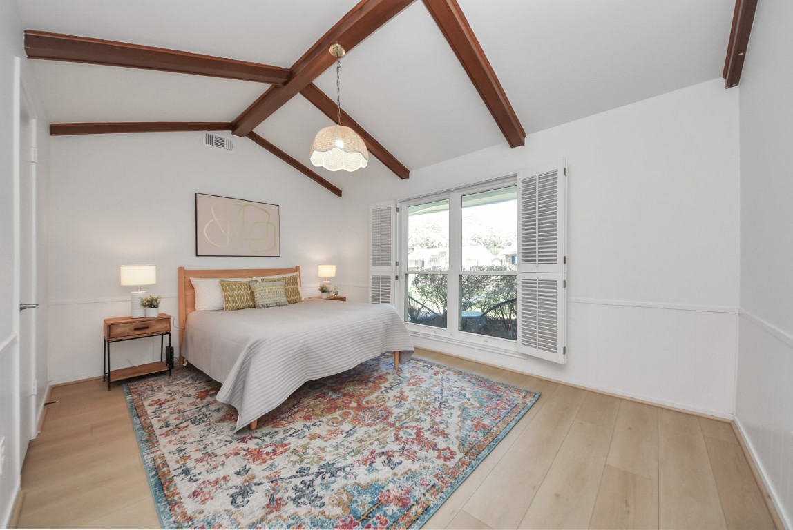 10719 Burgoyne Road Houston, TX 77042 - Photo 14 of 36 This is the first secondary bedroom, featuring a lovely vaulted ceiling and large windows overlooking the front yard. All bedrooms offer generously sized closets.