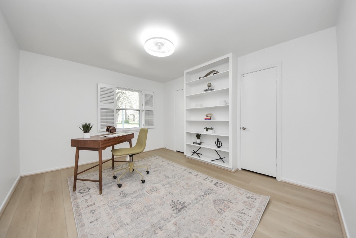 10719 Burgoyne Road Houston, TX 77042 - Photo 17 of 36 Bedroom #2 features a front-facing window and a built-in shelf/bookcase.