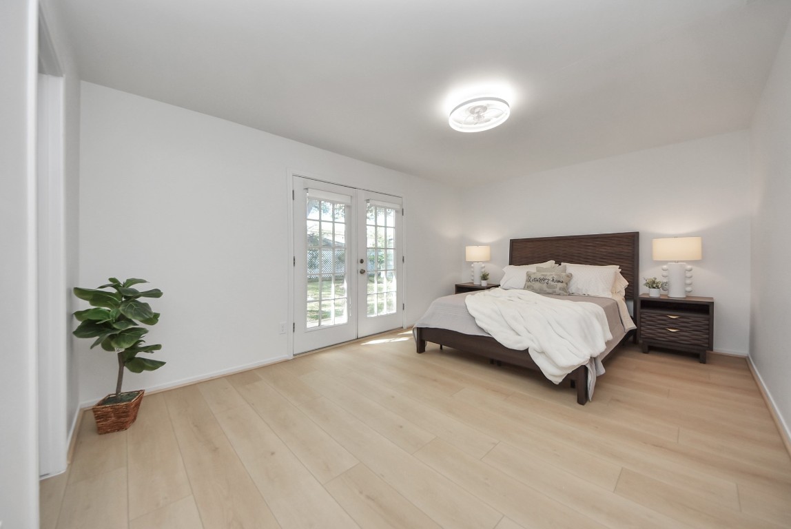 10719 Burgoyne Road Houston, TX 77042 - Photo 21 of 36 The primary bedroom is located at the end of the hallway, offering additional privacy, with views of the backyard and direct access