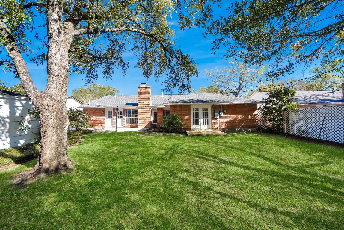 10719 Burgoyne Road Houston, TX 77042 - Photo 27 of 36 Spacious backyard with plenty of green space and mature trees—perfect for enjoying this beautiful weather.