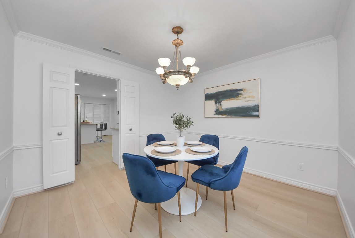 10719 Burgoyne Road Houston, TX 77042 - Photo 6 of 36 Filled with natural light, the dining room connects directly to the kitchen and can easily be closed off for added privacy when desired.