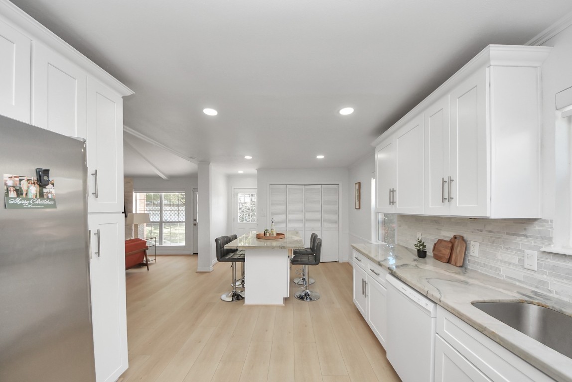 10719 Burgoyne Road Houston, TX 77042 - Photo 8 of 36 As you enter the kitchen, it opens up to a built-in island table, perfect for seating or meal prep while overlooking the family room.