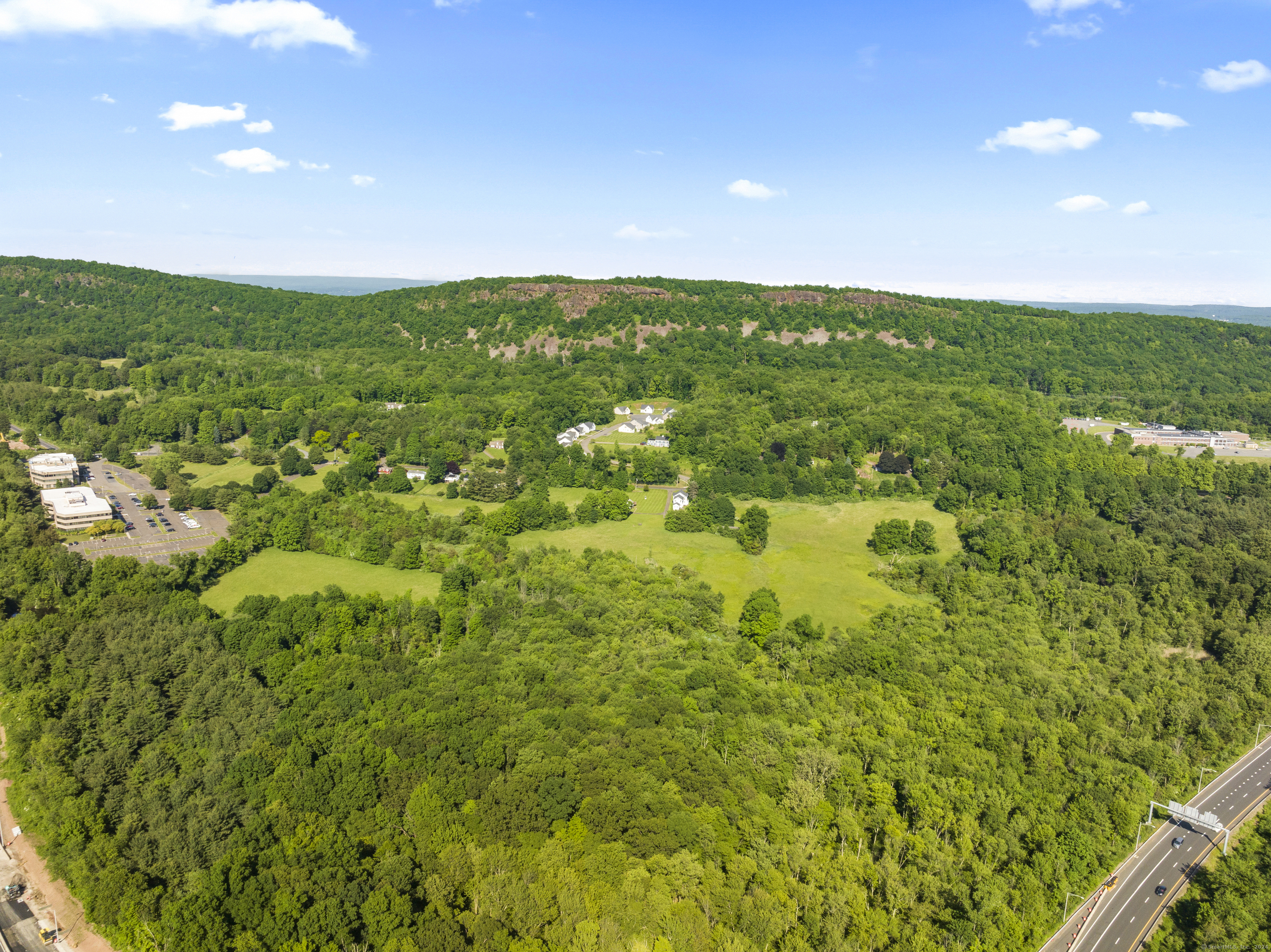 436-444 Preston Avenue Meriden, CT 06450 - Photo 4 of 14 a view of a green field with lots of bushes
