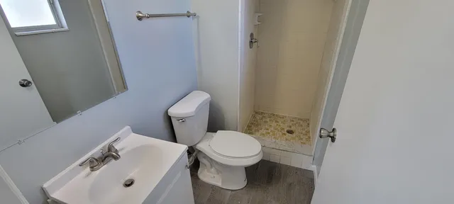 a white toilet sitting next to a bathroom sink