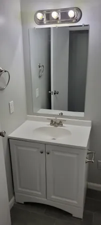 a bathroom with a sink and a mirror