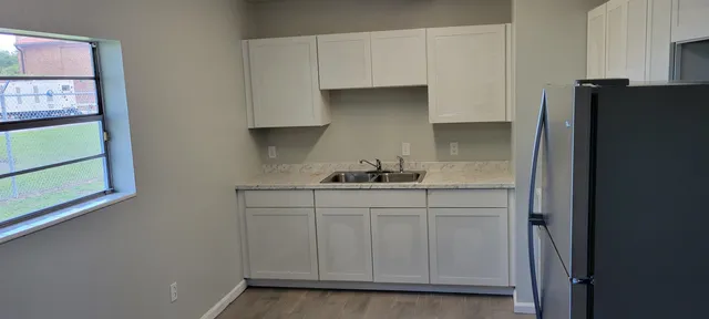 a kitchen with stainless steel appliances a sink and cabinets