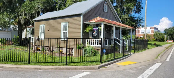 a view of a house with a backyard and a garden