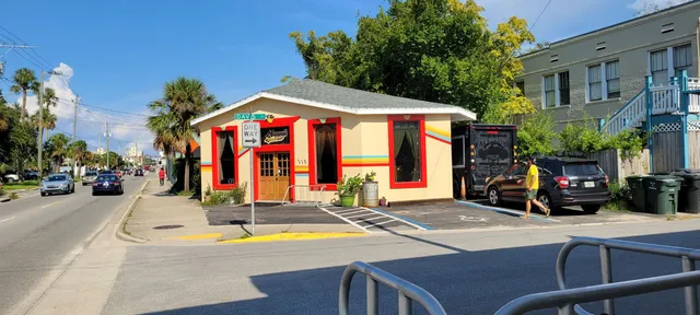 a view of a building with sitting area and furniture