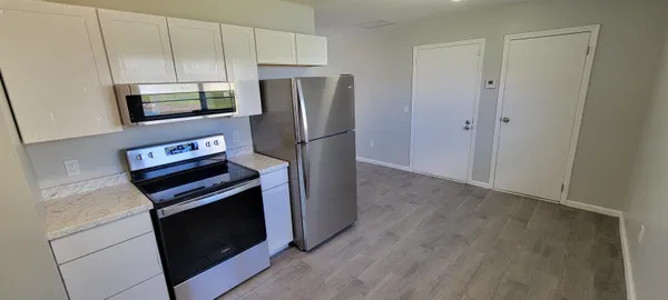 a kitchen with stainless steel appliances a refrigerator stove and microwave