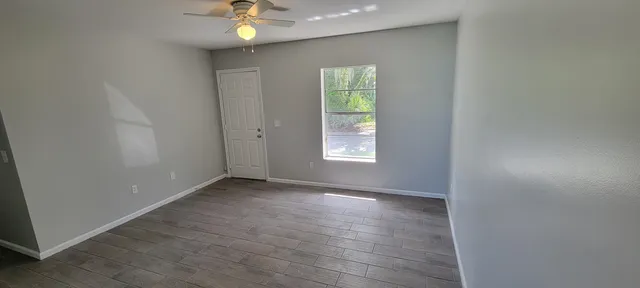 an empty room with closet and a window