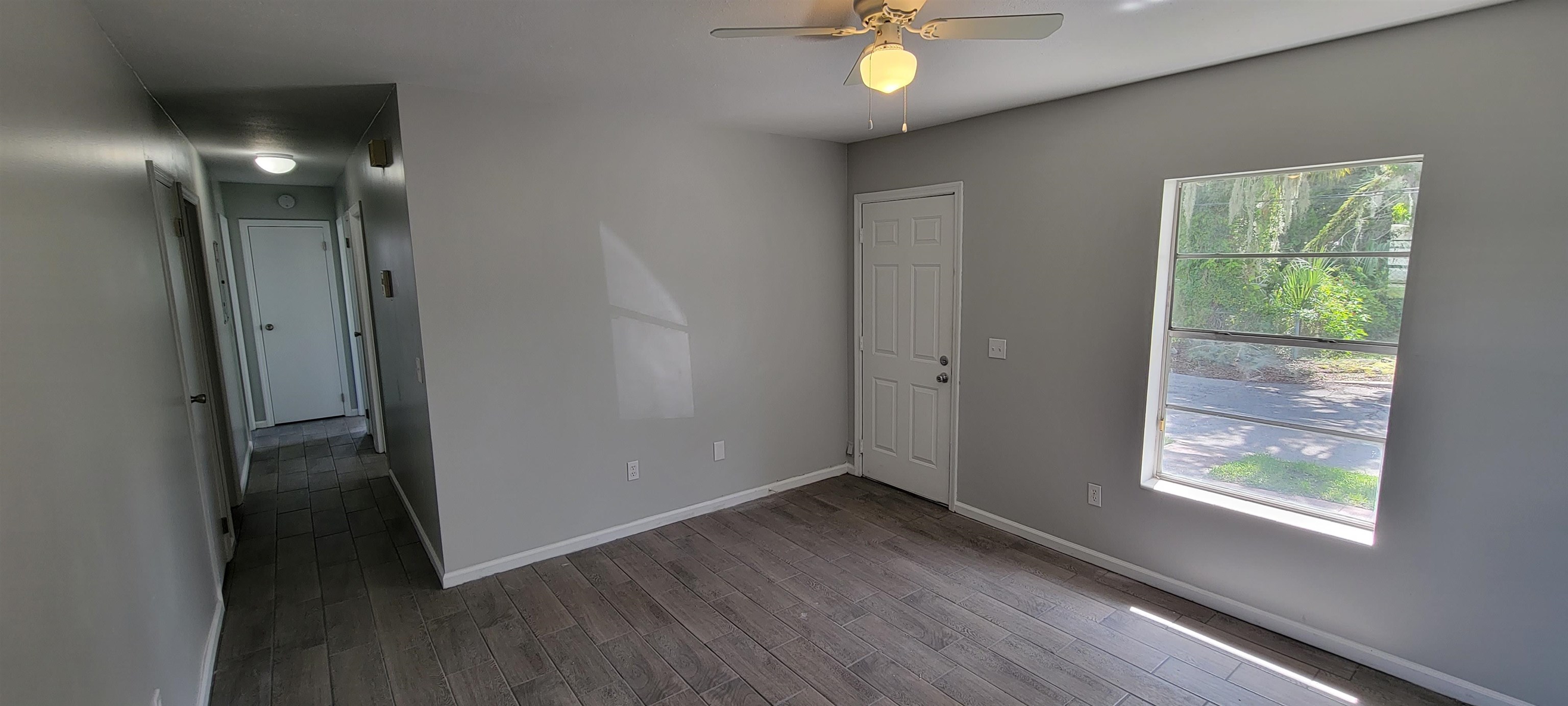 3 Travis Lane St. Augustine, FL 32084 - Photo 8 of 27 an empty room with wooden floor and windows