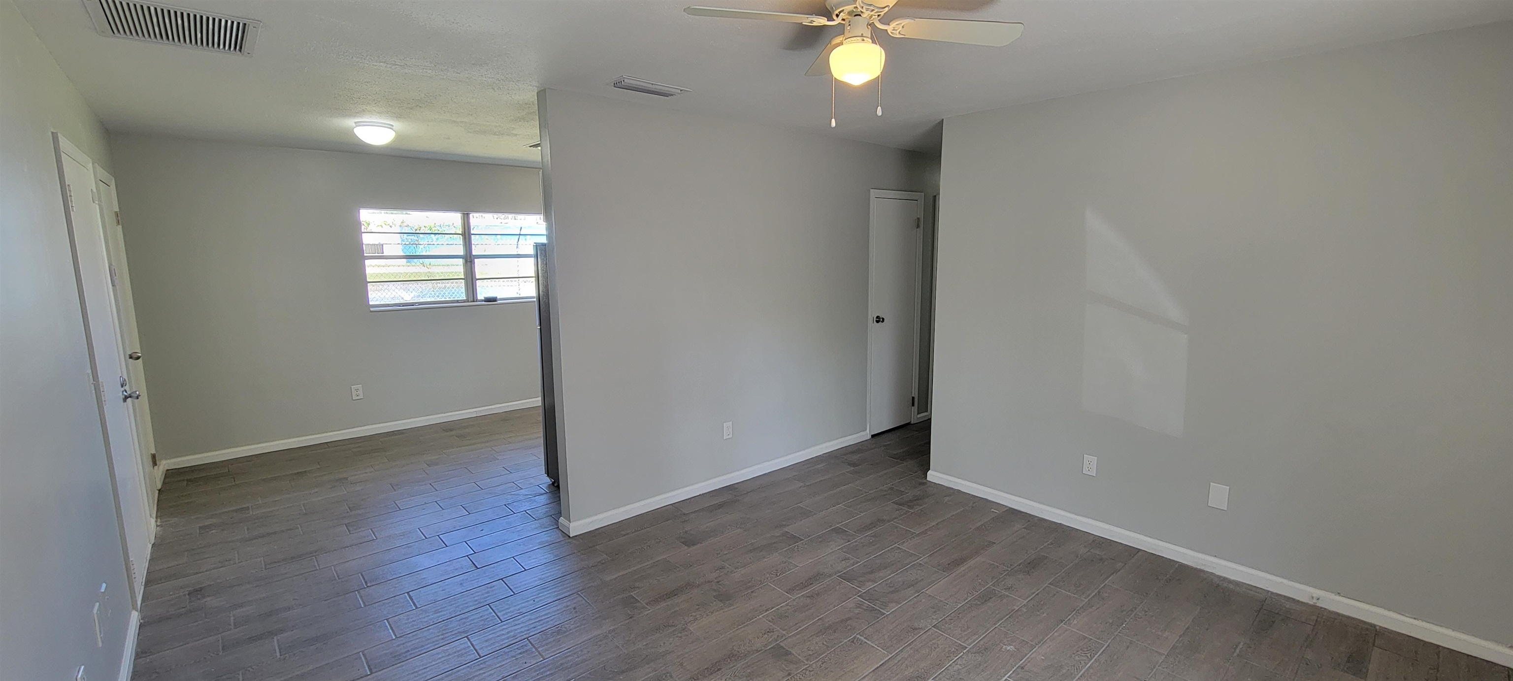 3 Travis Lane St. Augustine, FL 32084 - Photo 9 of 27 an empty room with wooden floor and windows