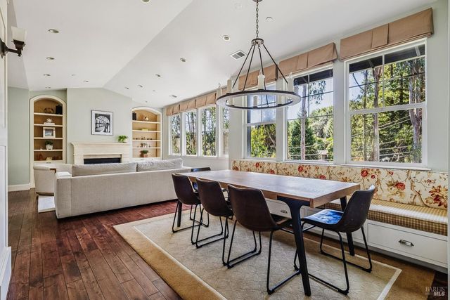 a kitchen with stainless steel appliances granite countertop a sink a stove and chairs