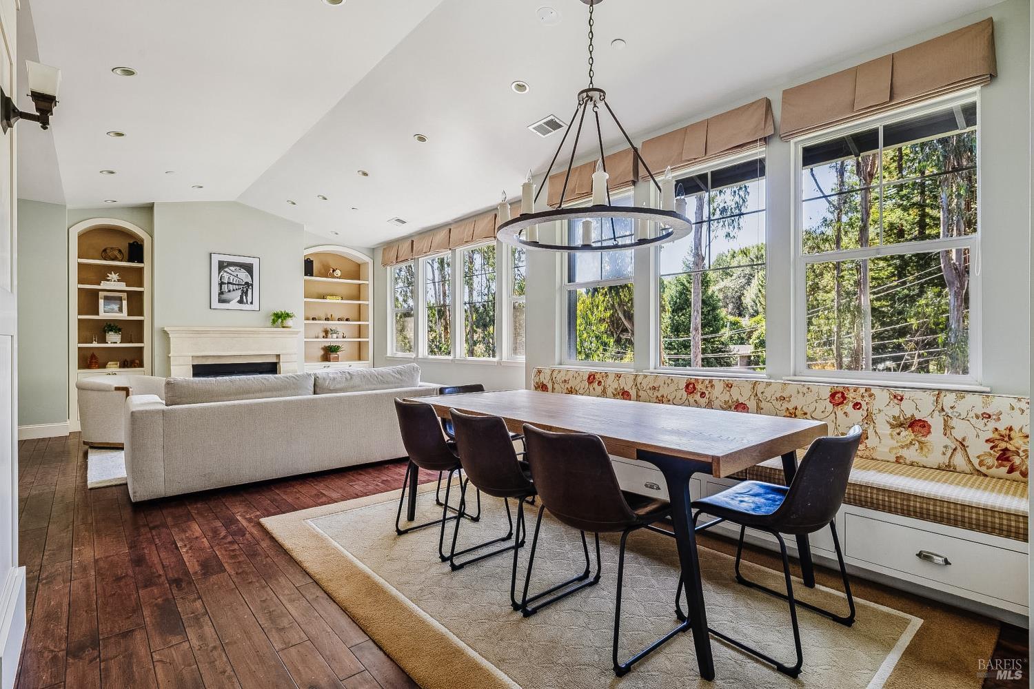 529 Alta Way Mill Valley, CA 94941 - Photo 11 of 58 a dining room with wooden floor a chandelier a wooden table and chairs