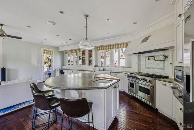 a kitchen with a table chairs refrigerator and window
