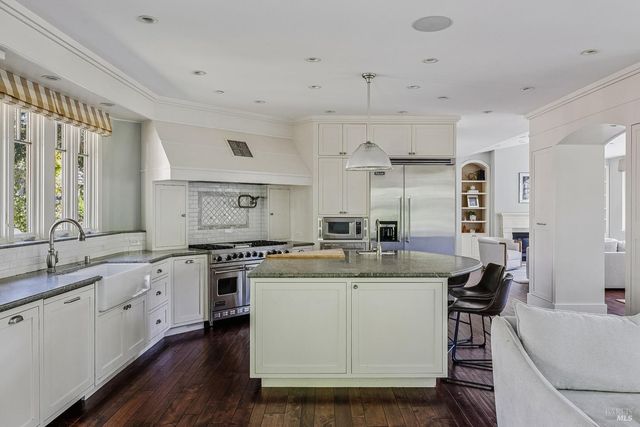 a kitchen with stainless steel appliances granite countertop a sink and stove