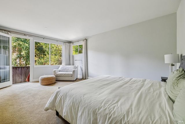 a bedroom with a bed and chair