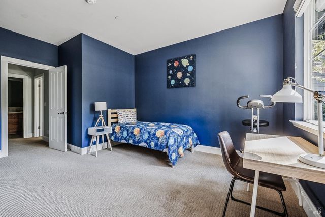 a view of a brick house with a yard and potted plants