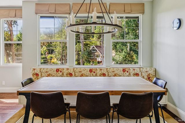 a kitchen with a stove a table and chairs