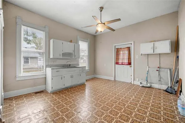 a kitchen with granite countertop white cabinets and a window