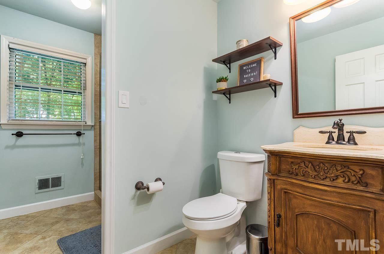 9028 Oneal Road Raleigh, NC 27613 - Photo 13 of 30 a spacious bathroom with a granite countertop toilet sink and mirror