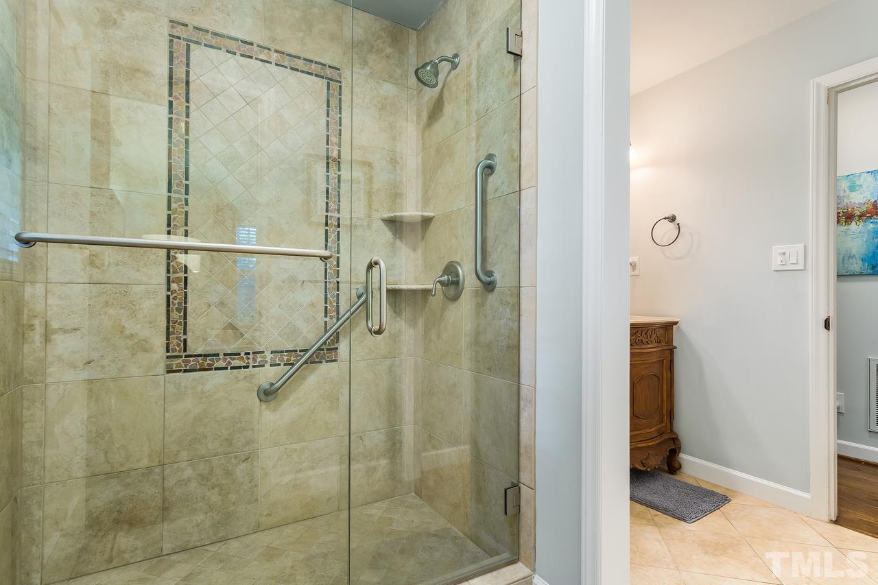 9028 Oneal Road Raleigh, NC 27613 - Photo 14 of 30 a bathroom with a glass shower door