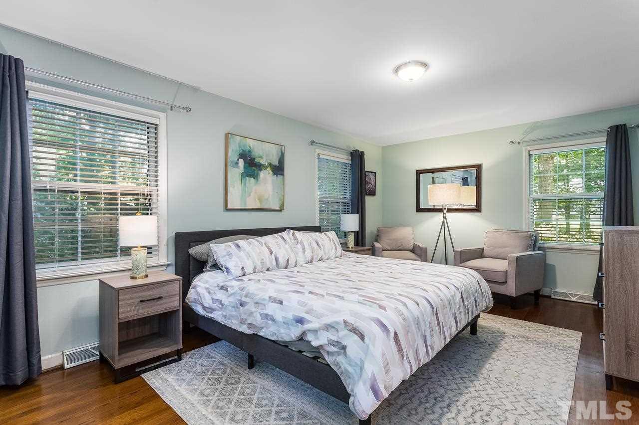 9028 Oneal Road Raleigh, NC 27613 - Photo 16 of 30 a bedroom with a large bed and a window