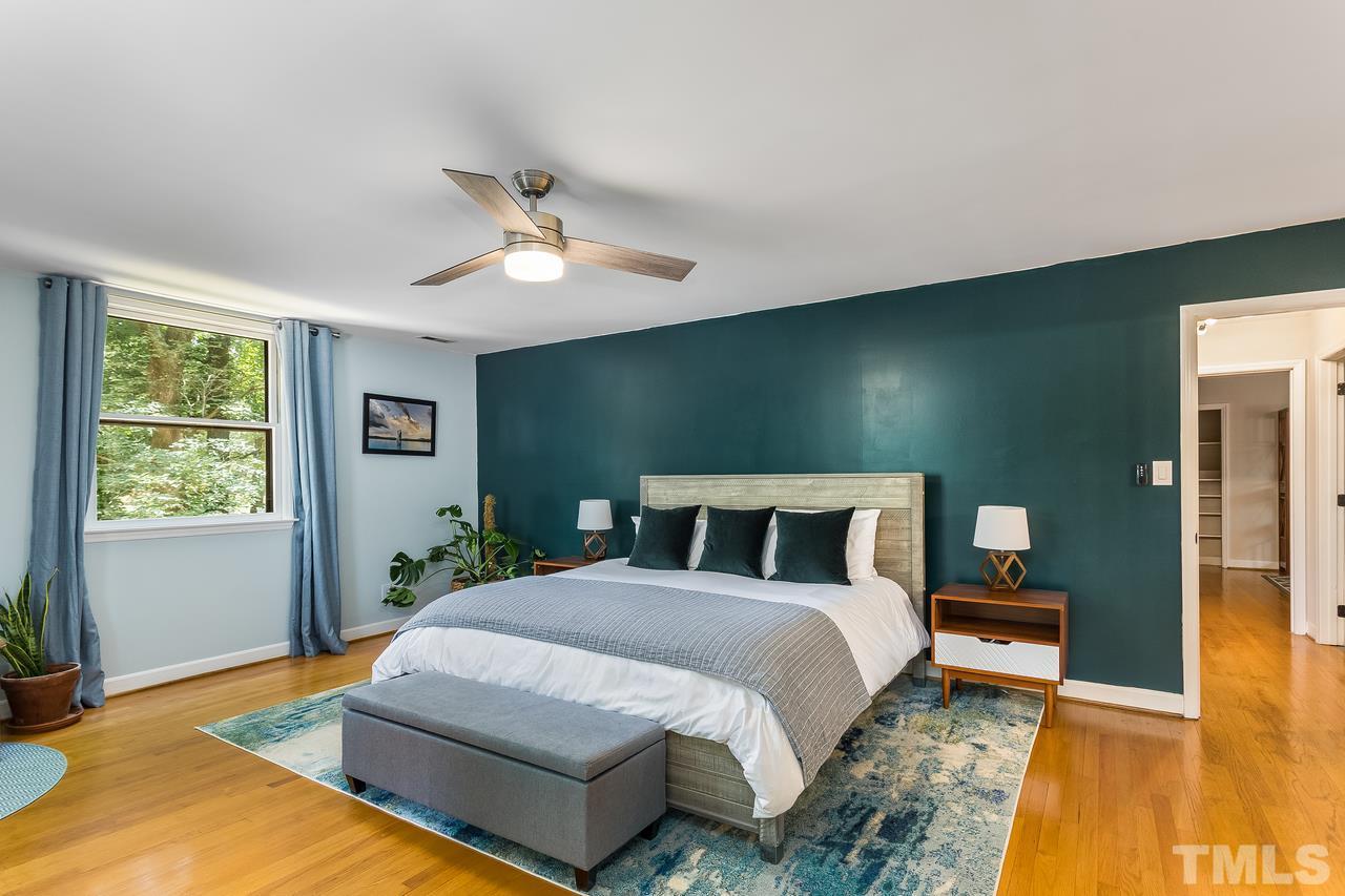9028 Oneal Road Raleigh, NC 27613 - Photo 18 of 30 a bedroom with a bed and wooden floor