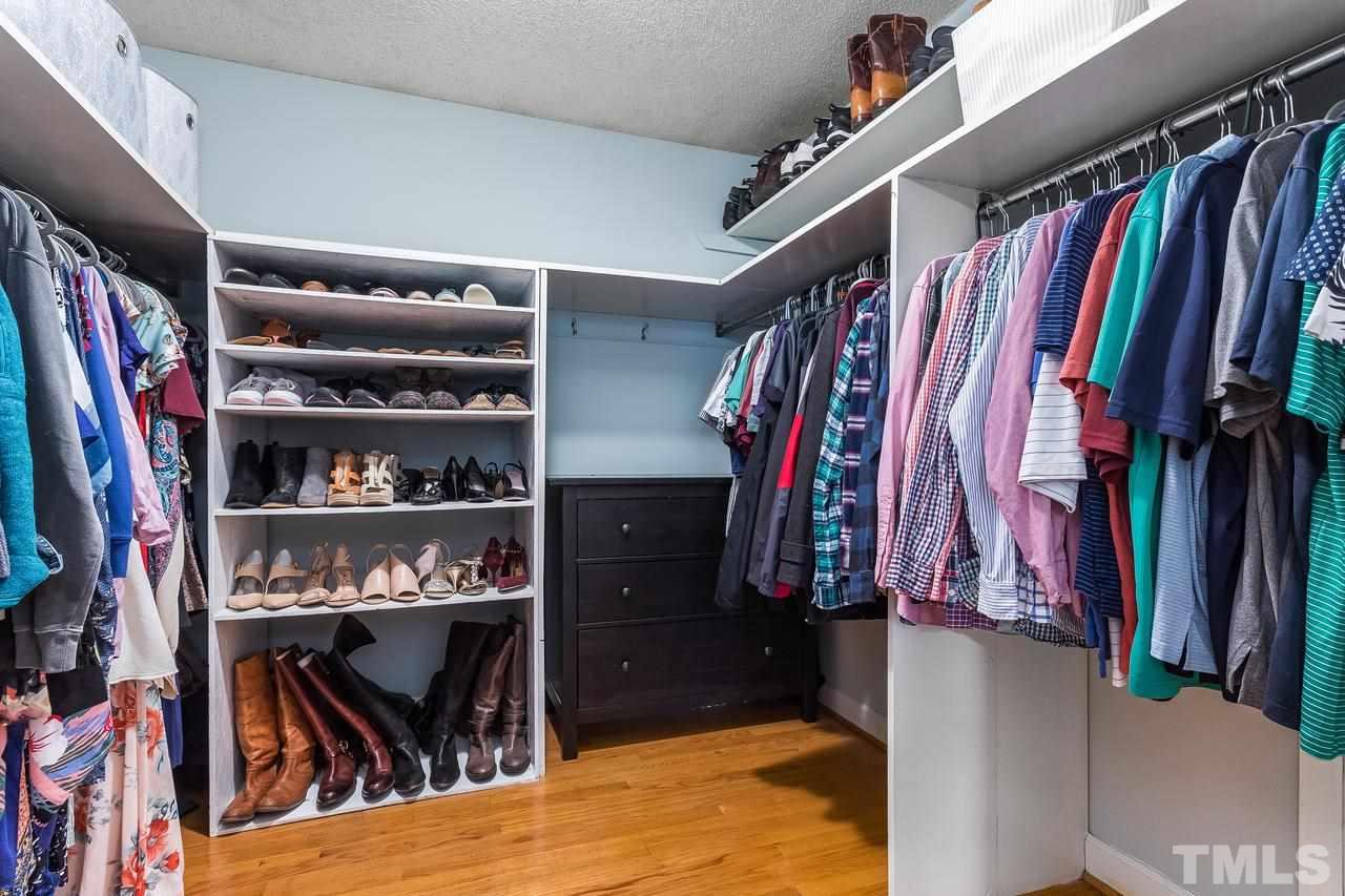 9028 Oneal Road Raleigh, NC 27613 - Photo 19 of 30 a view of walk in closet with clothes and shoes