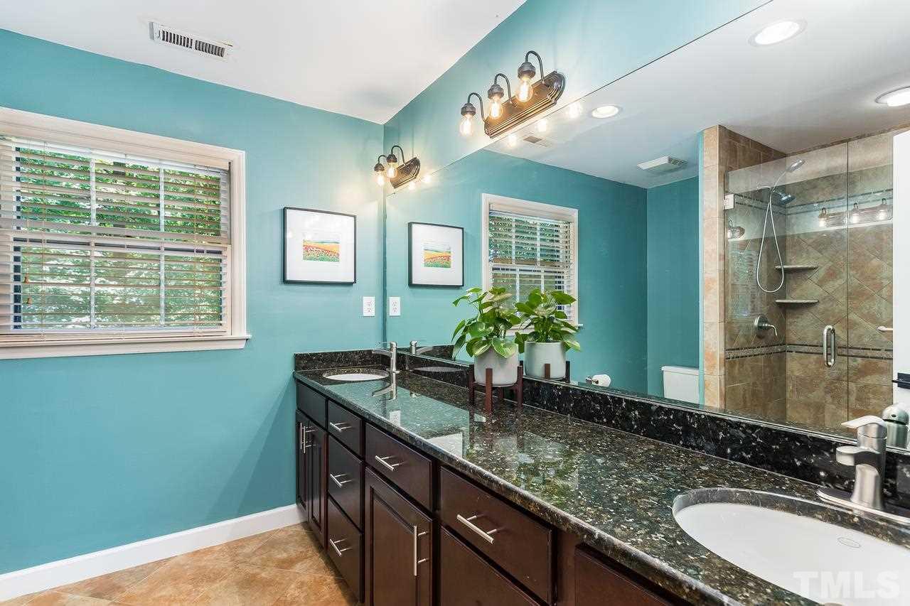 9028 Oneal Road Raleigh, NC 27613 - Photo 20 of 30 a bathroom with a granite countertop sink and a mirror