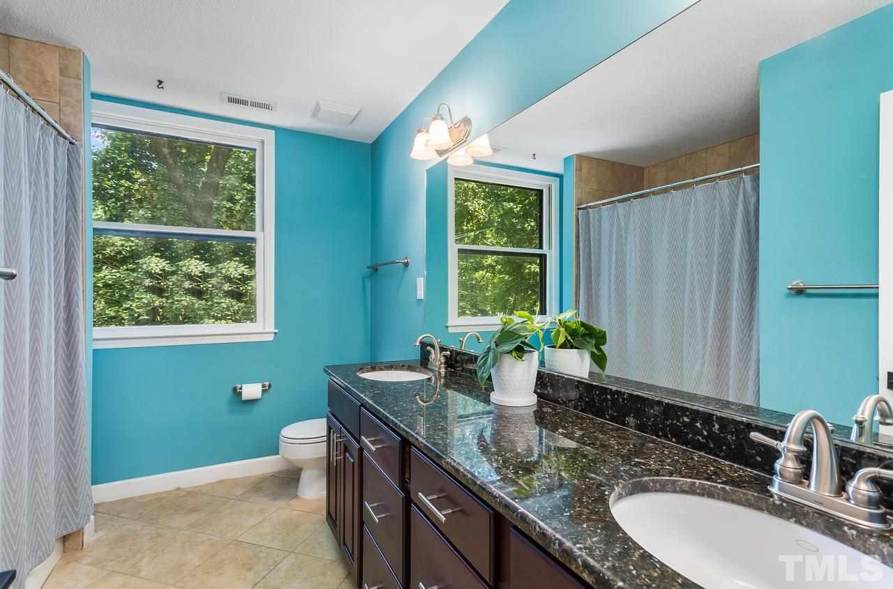 9028 Oneal Road Raleigh, NC 27613 - Photo 25 of 30 a bathroom with a granite countertop sink and a window
