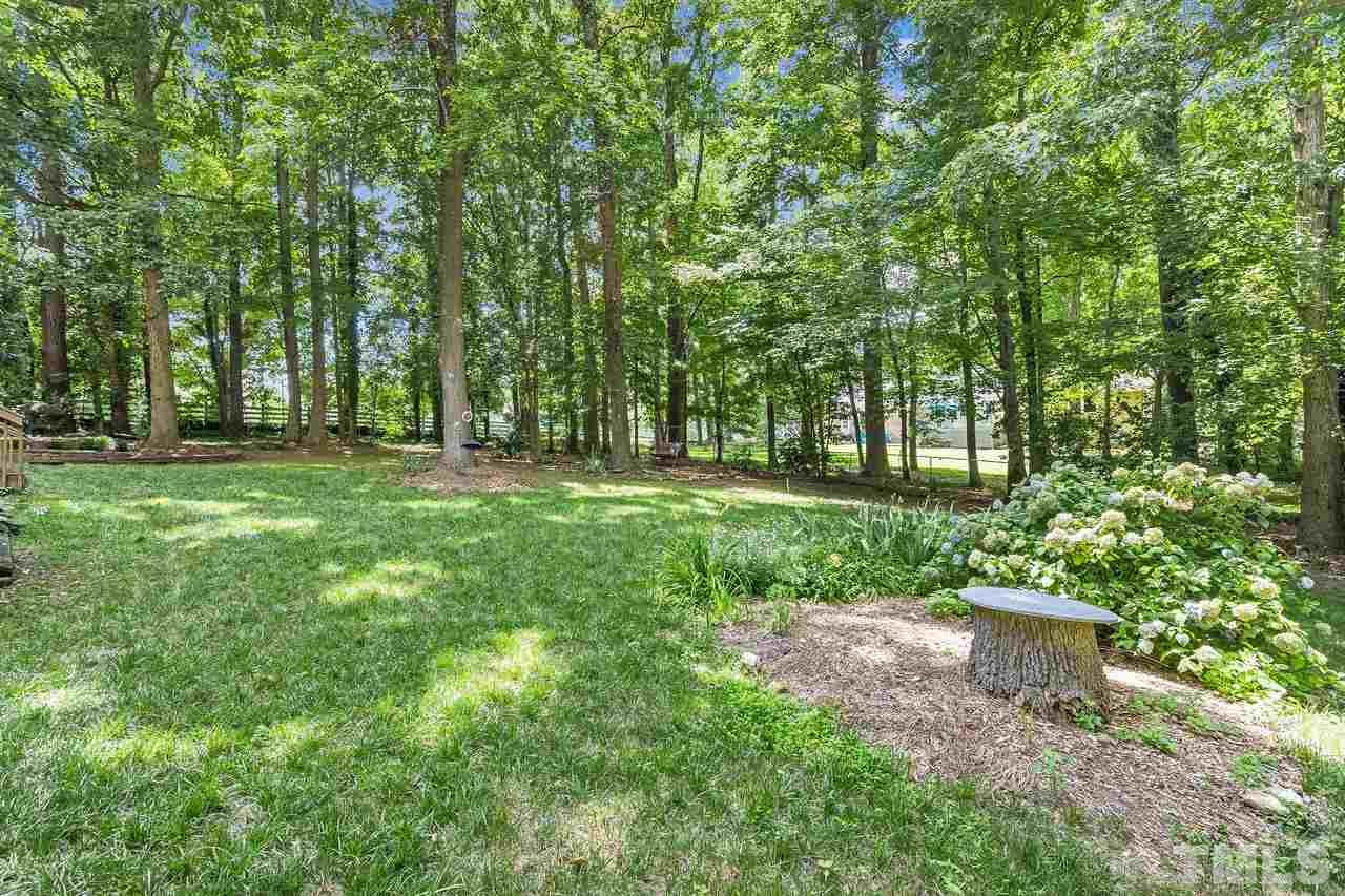 9028 Oneal Road Raleigh, NC 27613 - Photo 28 of 30 a big yard with lots of green space and plants