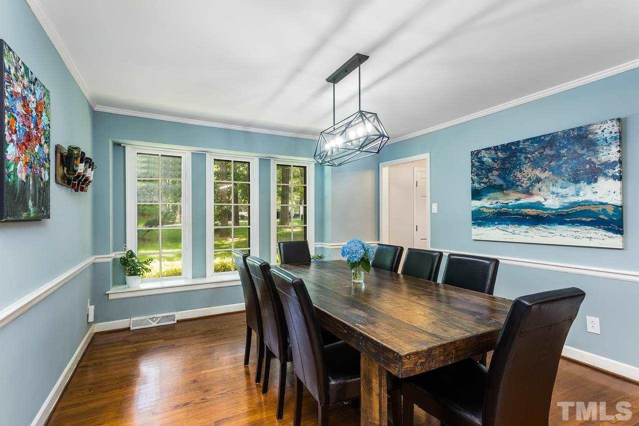 9028 Oneal Road Raleigh, NC 27613 - Photo 5 of 30 a view of a dining room with furniture window and wooden floor