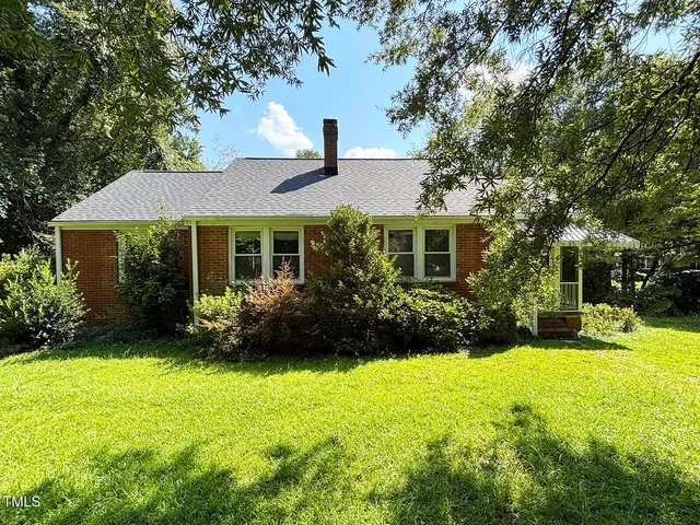 a front view of a house with a garden and porch