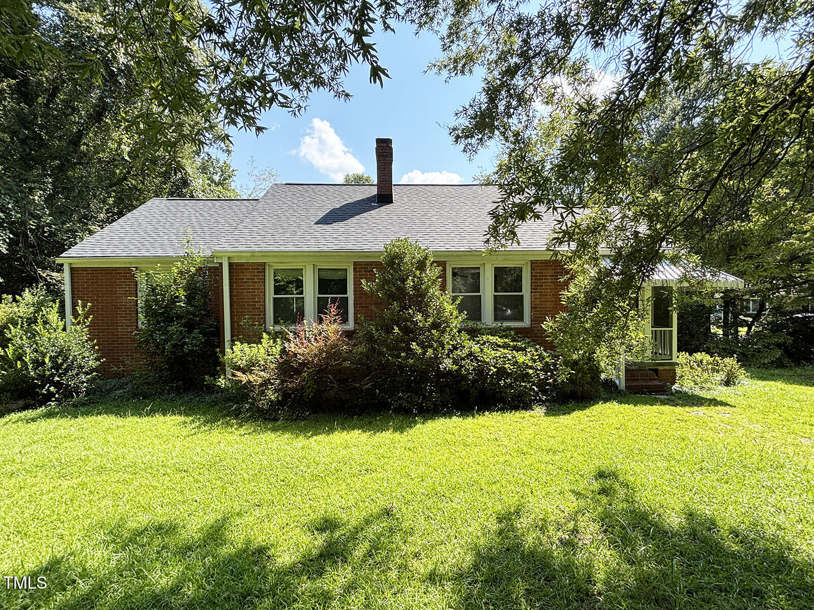 a front view of a house with a garden and porch
