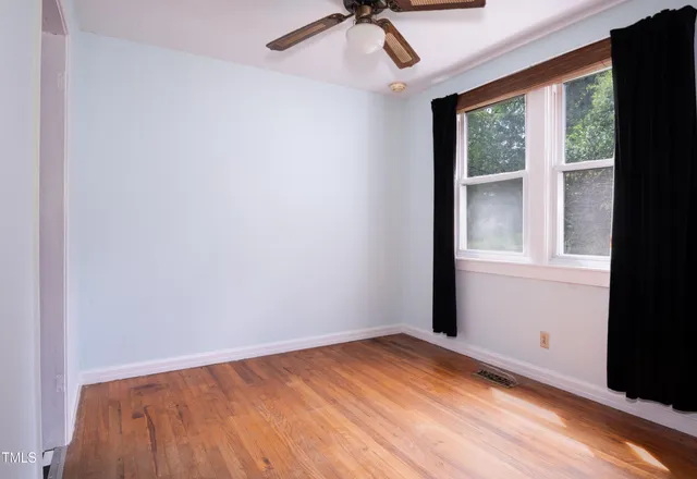 a view of a dining room with furniture and a window
