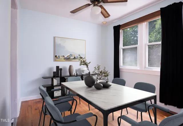 a kitchen with a checkered floor and white cabinets