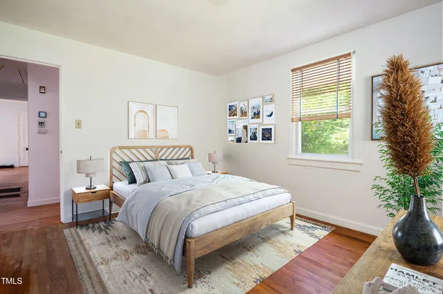 a bedroom with a bed and a potted plant