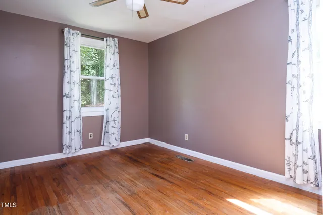a view of an empty room and wooden floor