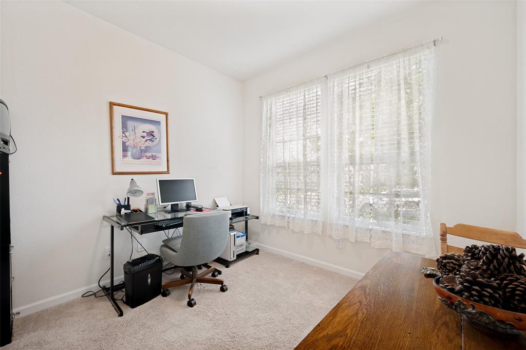 413 Wiggins Way Van Alstyne, TX 75495 - Photo 21 of 25 Light-filled room featuring neutral-toned carpeting and white walls