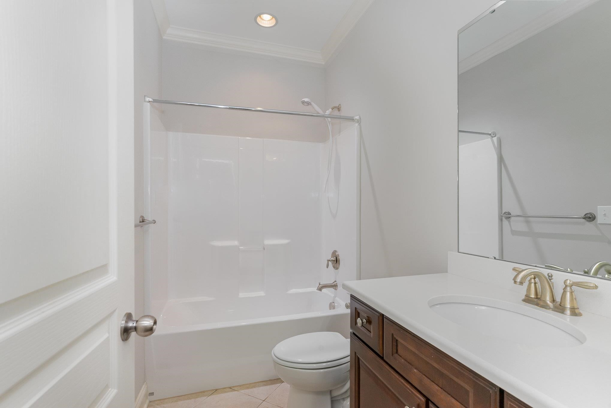 702 Chapanoke Road Raleigh, NC 27603 - Photo 19 of 39 a bathroom with a sink a toilet and a large mirror