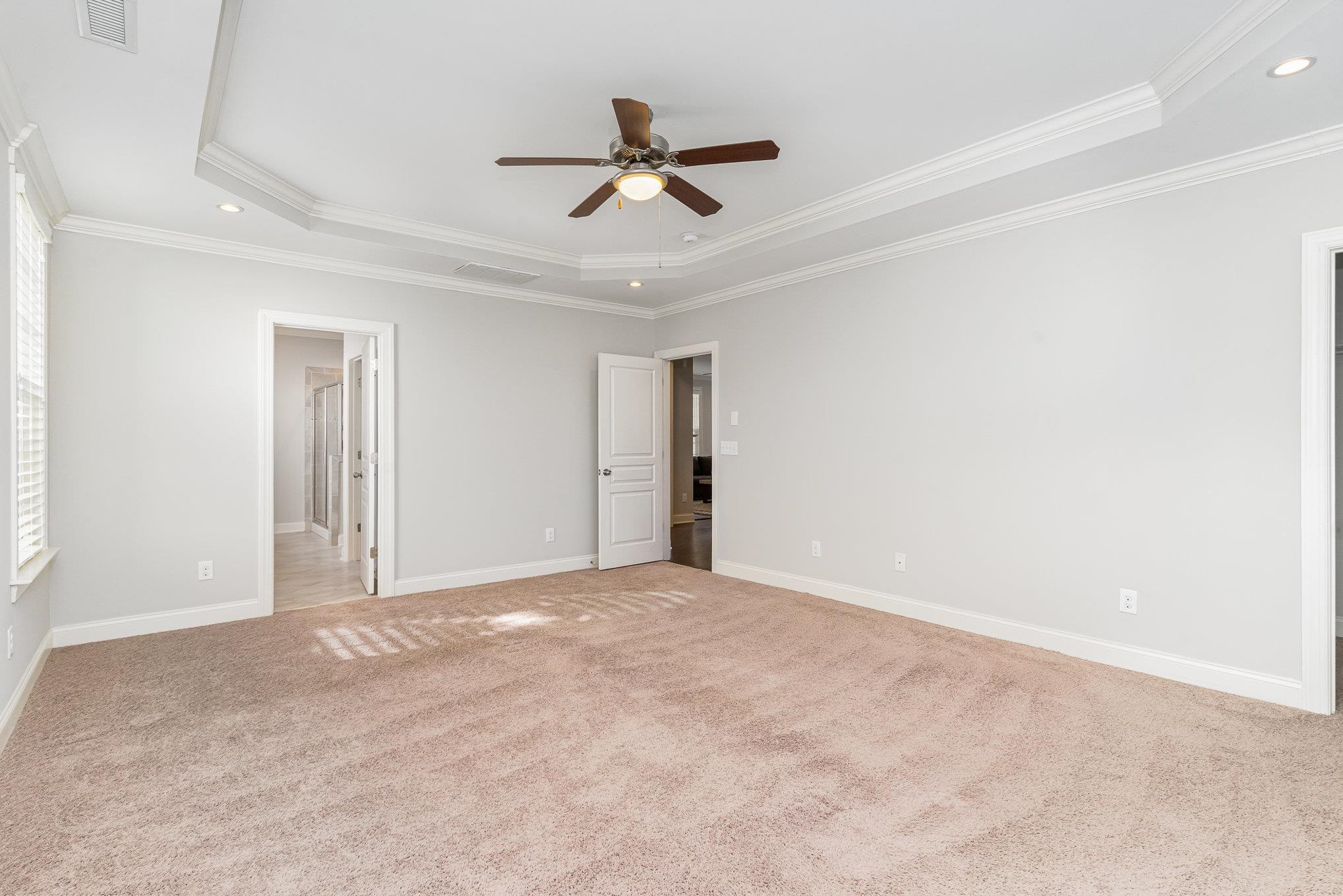 702 Chapanoke Road Raleigh, NC 27603 - Photo 21 of 39 a view of a livingroom with a ceiling fan & windows