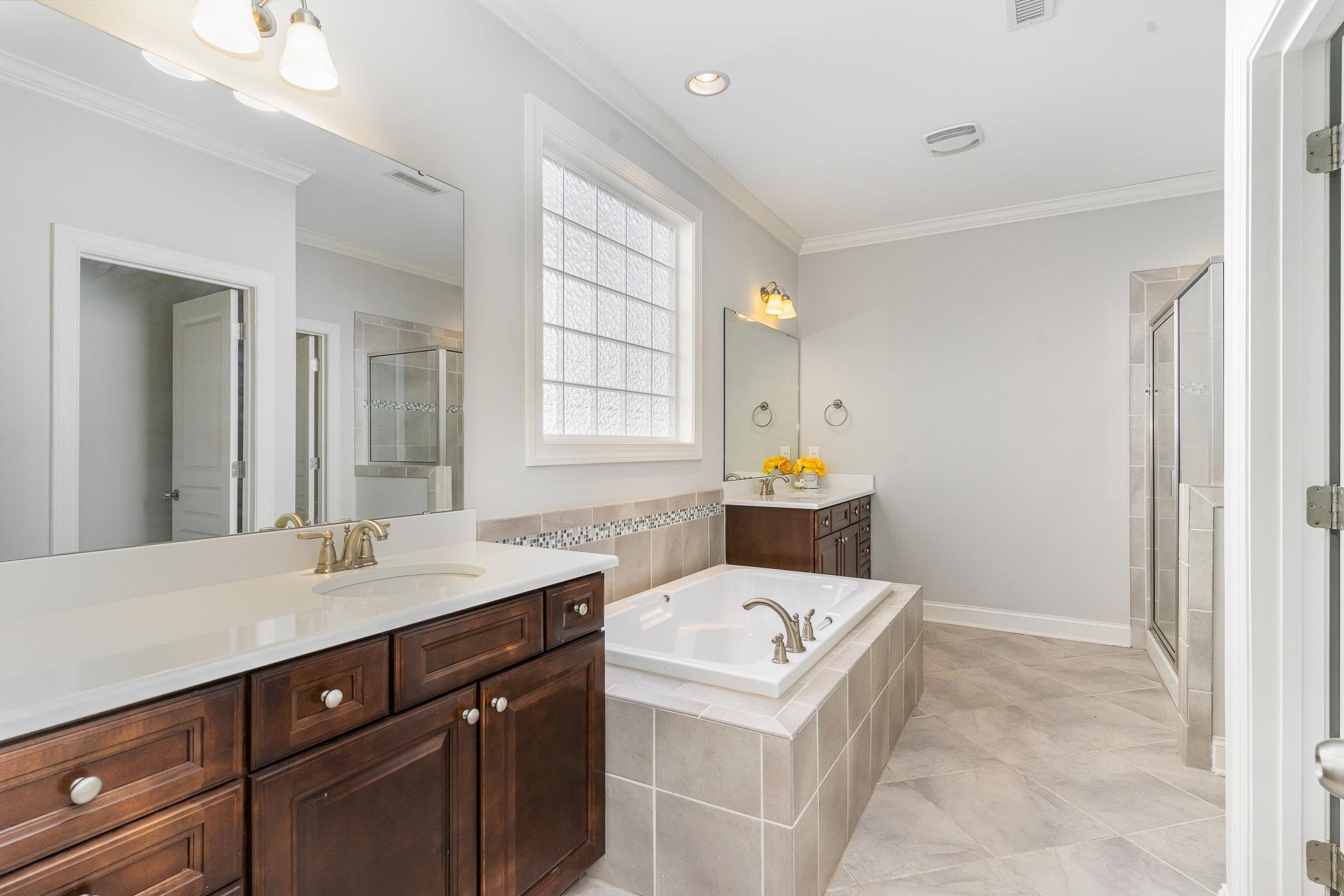 702 Chapanoke Road Raleigh, NC 27603 - Photo 22 of 39 a bathroom with a sink a vanity a mirror and a bathtub