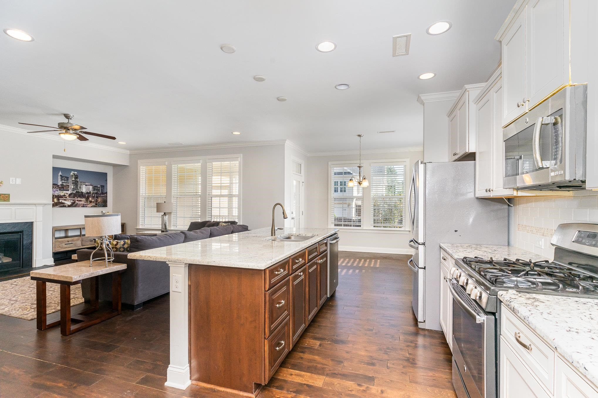 702 Chapanoke Road Raleigh, NC 27603 - Photo 8 of 39 a large kitchen with stainless steel appliances granite countertop a lot of counter space and a sink