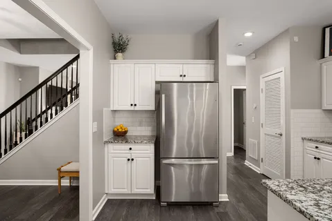 a kitchen with stainless steel appliances a refrigerator and a stove top oven